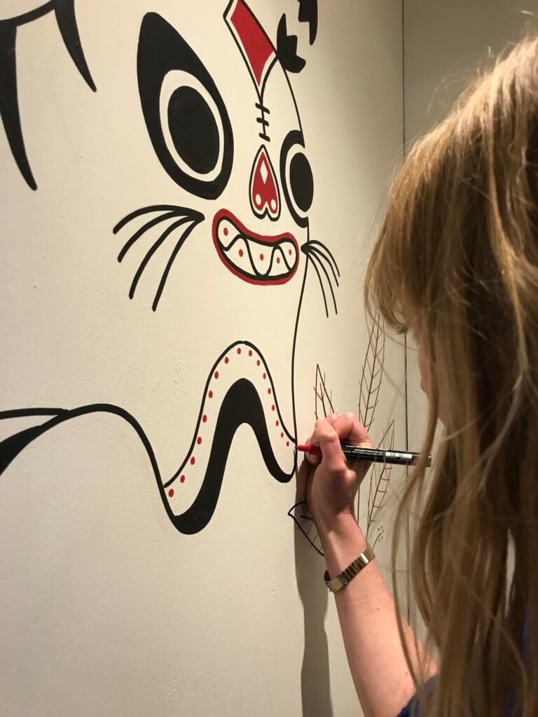 Camille Roy drawing the Panda Panda mural — Camille Roy